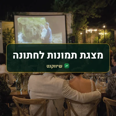 מצגת תמונות לחתונה: חתן וכלה צופים במסך גדול באולם, מוקפים באורחים, מצולמים מאחור